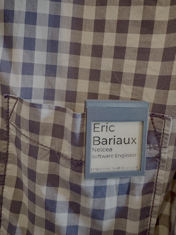 Badge based on eInk screen, clipped on shirt pocket